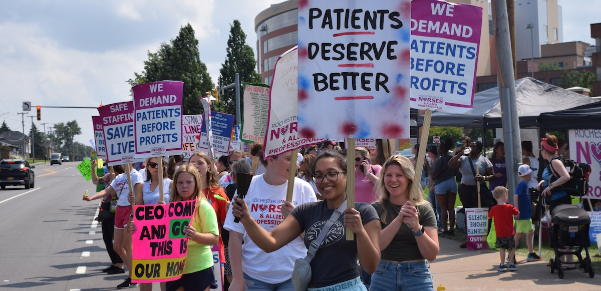Rochester nurses and healthcare workers standing together with picket signs